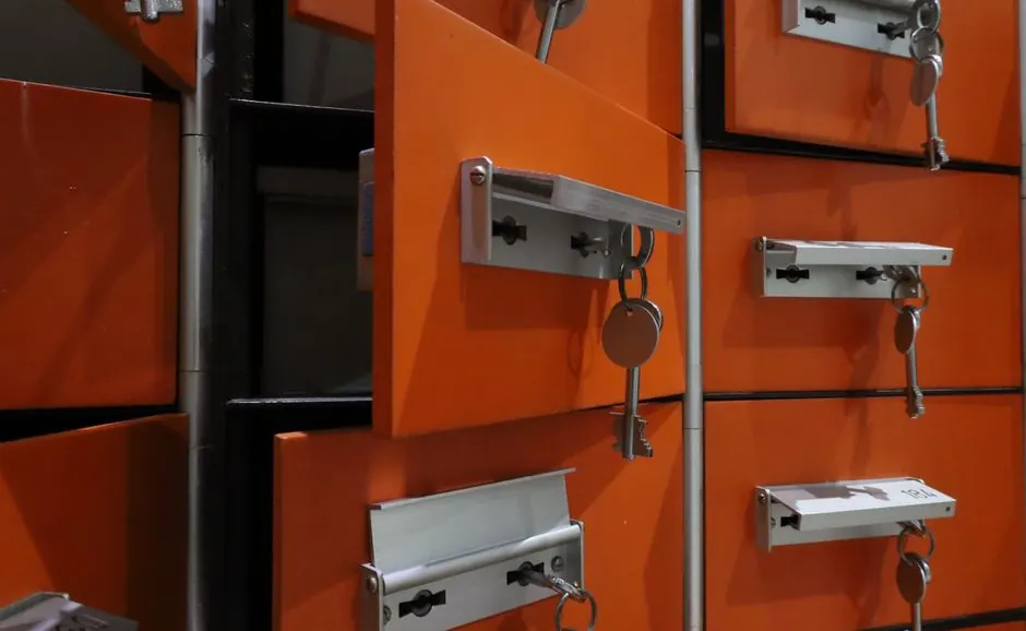Orange lockers with metal keys highlighted in an indoor setting.