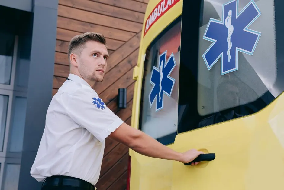 Paramedic preparing ambulance for immediate medical assistance. Emergency response visualized.